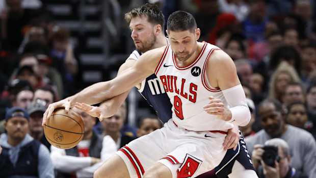 Dallas Mavericks guard Luka Doncic (77) defends against Chicago Bulls center Nikola Vucevic (9) during the second half at United Center.